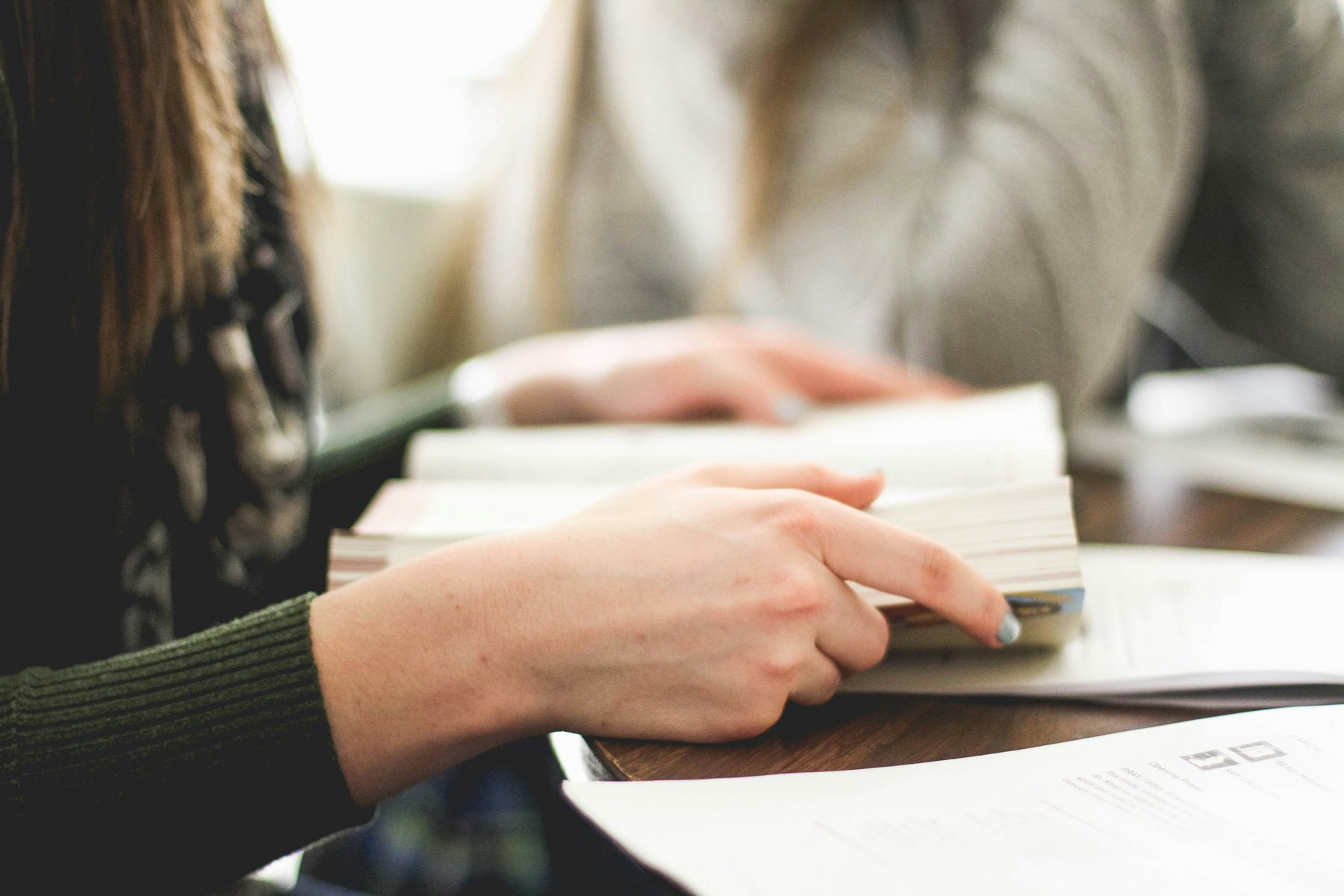 A student reading printed study material